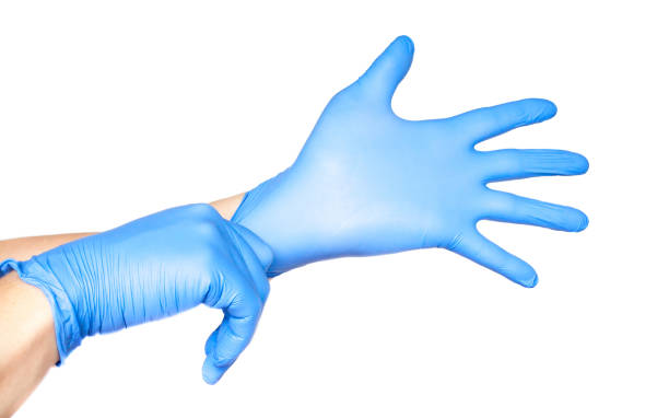 istock Doctor putting on gloves isolated on white 1166640536