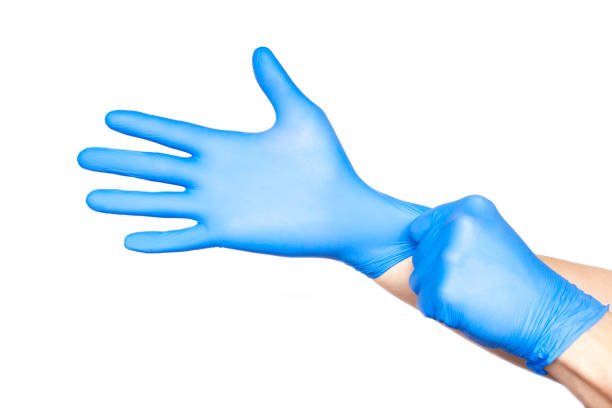 istock Doctor putting on gloves isolated on white 1166640573