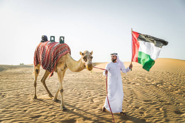 istock Arabian man with camel in the desert 1166640585