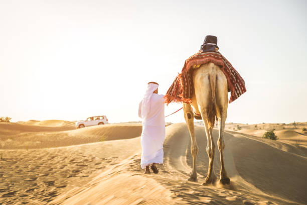 istock Arabian man with camel in the desert 1166640613
