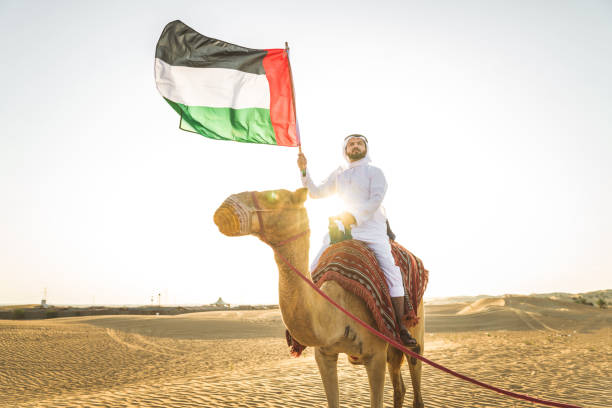 istock Arabian man with camel in the desert 1166640774