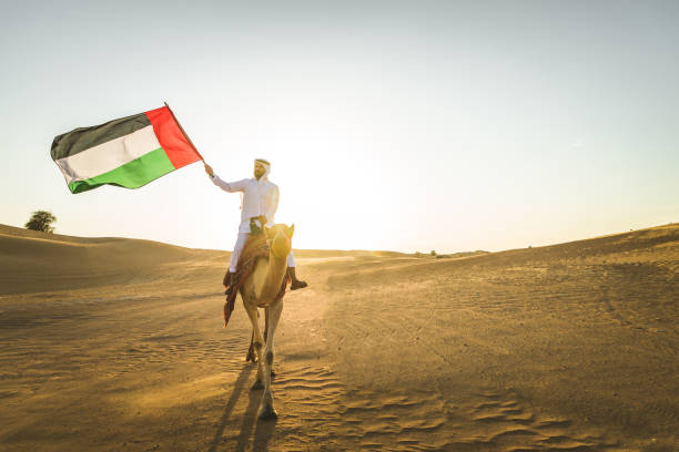 istock Arabian man with camel in the desert 1166640915