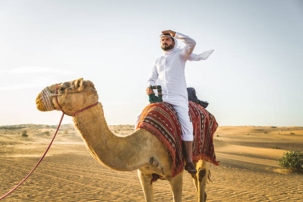 istock Arabian man with camel in the desert 1166641711