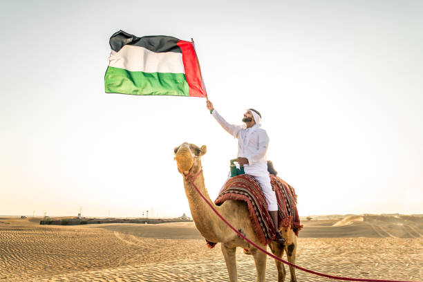 istock Arabian man with camel in the desert 1166641772