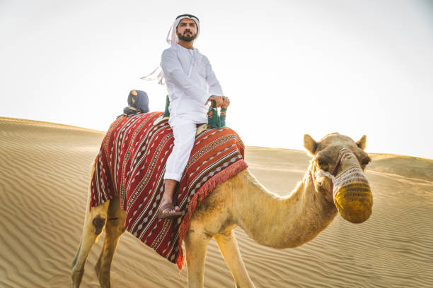 istock Arabian man with camel in the desert 1166641877