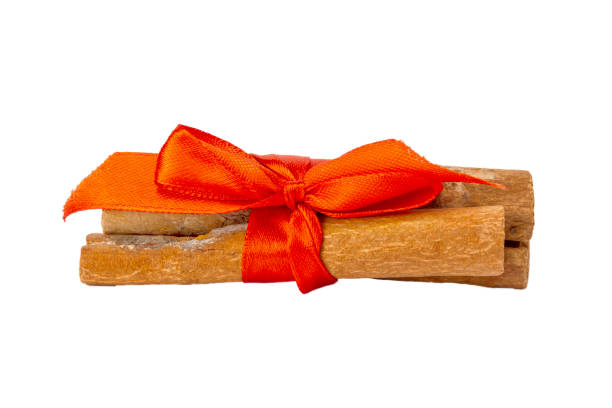 istock Cinnamon bandaged with red ribbon on a white background. 1166641934