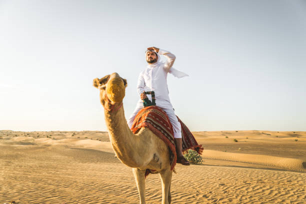 istock Arabian man with camel in the desert 1166641966