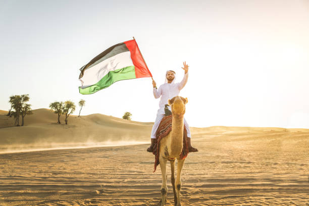 istock Arabian man with camel in the desert 1166642020