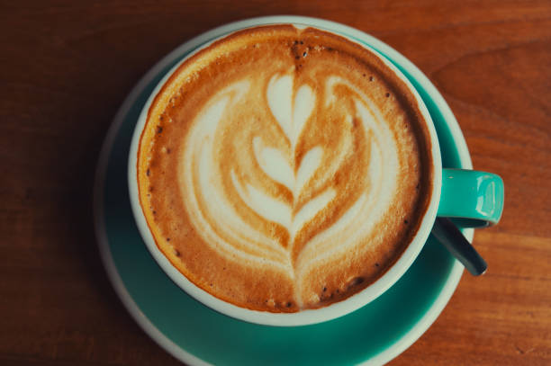 istock cup of coffee with cream on a wooden table 1166645864