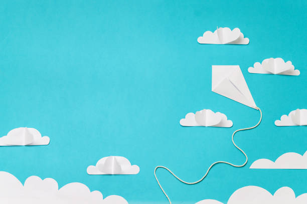 istock Paper cut clouds and origami kite composition. Creative concept for banner/landing/background designs. 1166649899