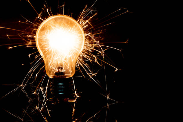 istock light bulb and sparkler in the dark 1166651106