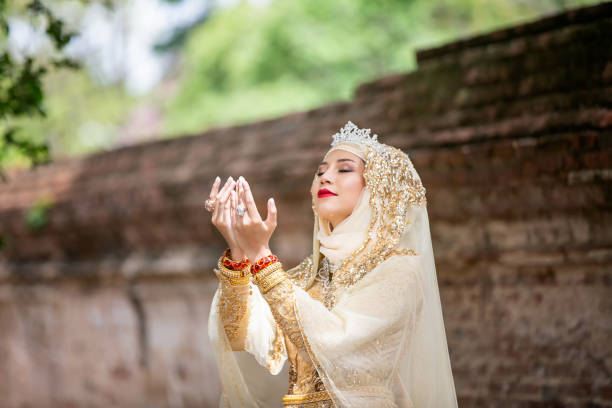 istock Woman Praying Against Brick Wall 1166652937