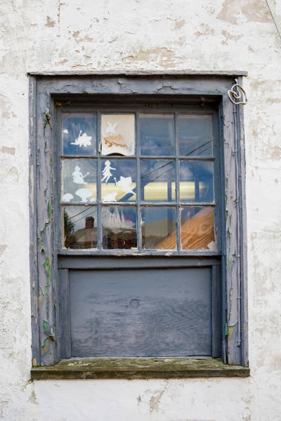 istock Old Window And Lots Of Cut Out Figurines 1166654301