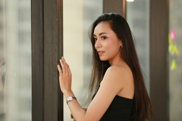 istock Beautiful Businesswoman Looking Away While Standing In Office 1166655870