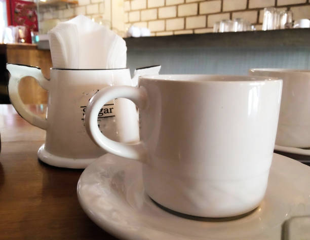 istock white mug and some sugar in the back 1166657593