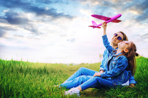 istock Girl playing with plane near mother 1166658708