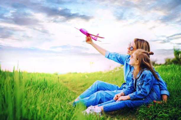 istock Mother playing with plane near daughter 1166658725