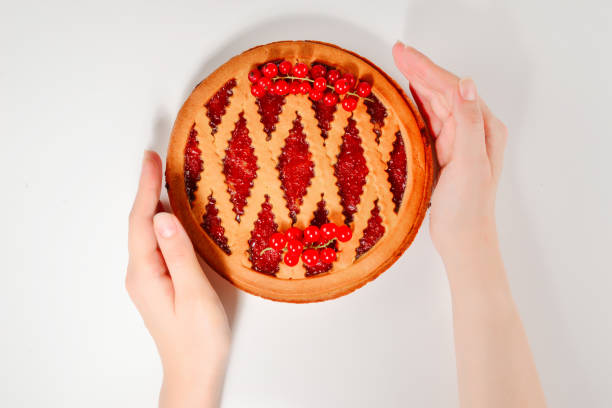 istock Strawberry pie in woman hands isolated on white background 1166659881