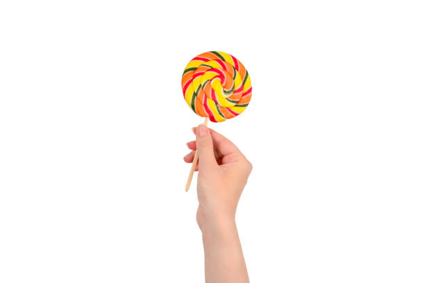istock Lollipop in female hand isolated on white  background. Space for text or design. 1166659910