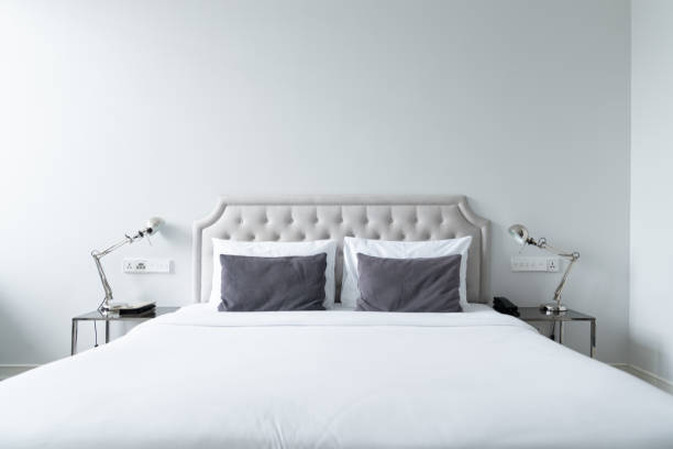 istock Cozy bedroom corner in minimal modern style with empty cool gray painted wall in the background / in terior concept / background for advertising. 1166660774