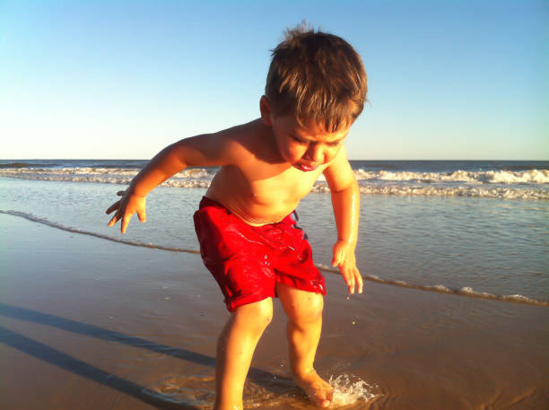 istock Boy playing and posing on Pinamar beach 1166661752