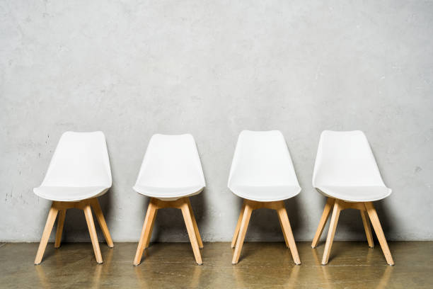 istock white chairs near grey concrete wall with copy space in office 1166661808