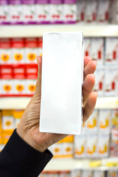 istock Hand with Milk bottle in supermarket 1166663105