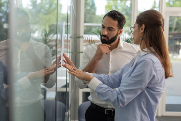 istock Serious brunette man touching his beard during conversation 1166663173