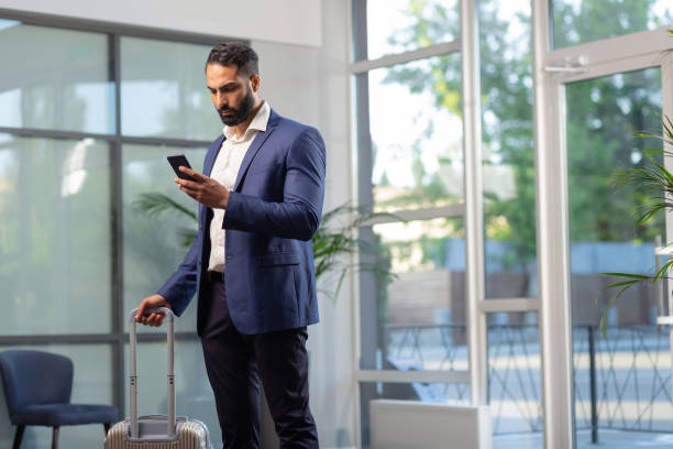 istock Serious bearded male person checking his email 1166663444