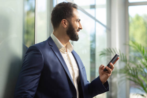 istock Cheerful young brunette man looking at window 1166663447