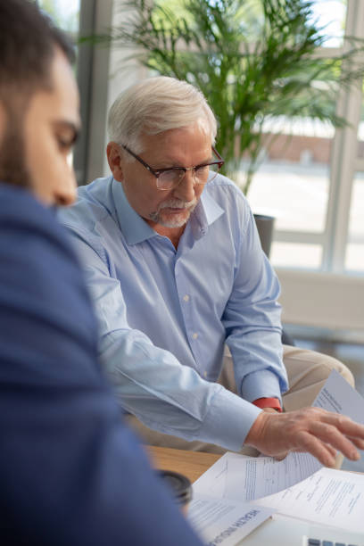 istock Concentrated bearded mature man pointing at computer 1166663468