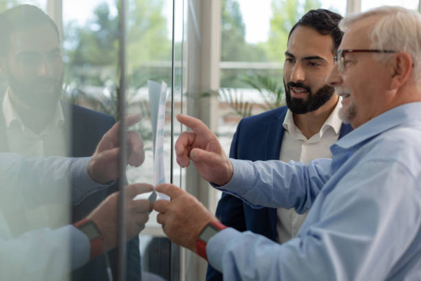 istock Delighted grey-haired businessman presenting his new idea 1166663526