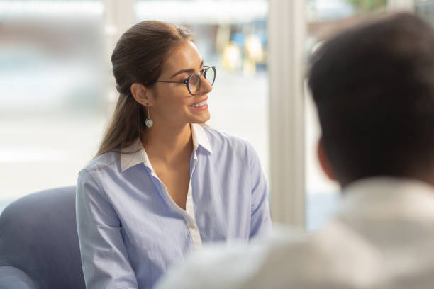 istock Cute longhaired office worker looking aside at partner 1166663615