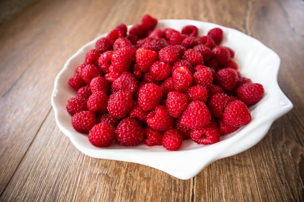 istock Fresh raw organic raspberries on a plate 1166666174