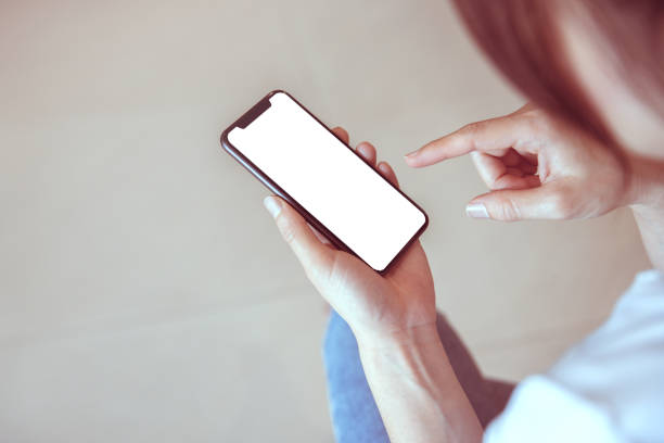 istock Hand touching smartphone with blank white screen in home, copy space. 1166666359