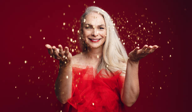 istock Cheerful senior woman throwing sparkles 1166667390