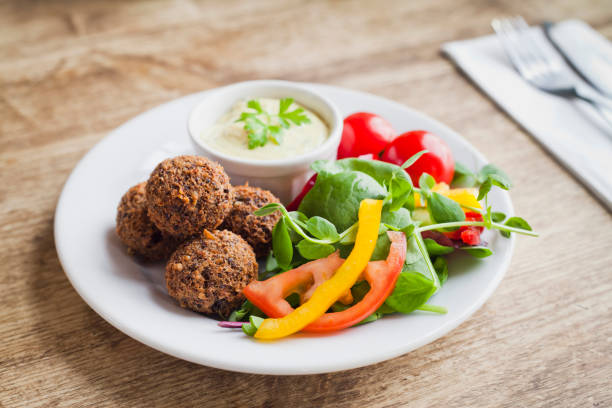 Breaded Haggis Balls - Scottish traditional dish as a starter. Breaded Haggis Balls - Scottish traditional dish as a starter. Served with fresh green leaves, creamy sauce and veggies. haggis stock pictures, royalty-free photos & images