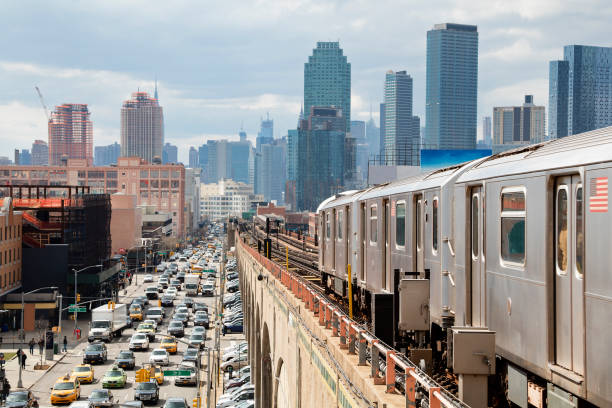 istock Subway Train Approaching  Elevated Subway Station in Queens, New York 1166668580