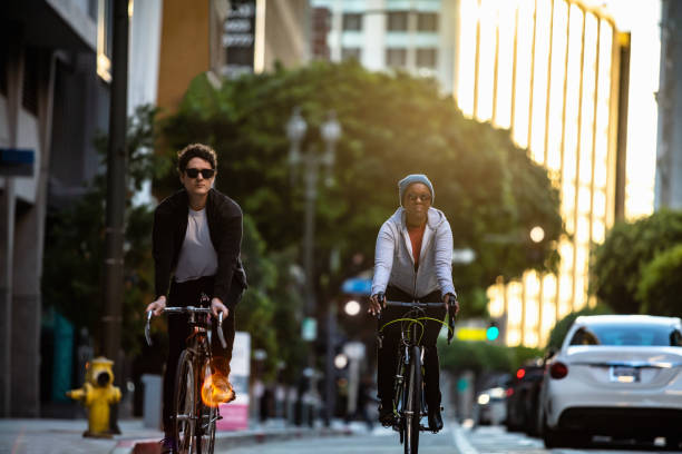 istock Two Cyclists on Left-Side Bike Lane on One Way Street 1166670876