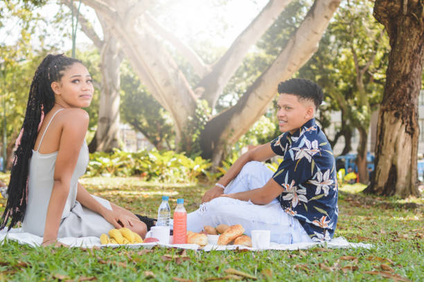 istock Young couple having picnic in a park 1166671888