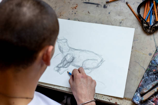 istock Young Male Artist Working On Painting 1166673398