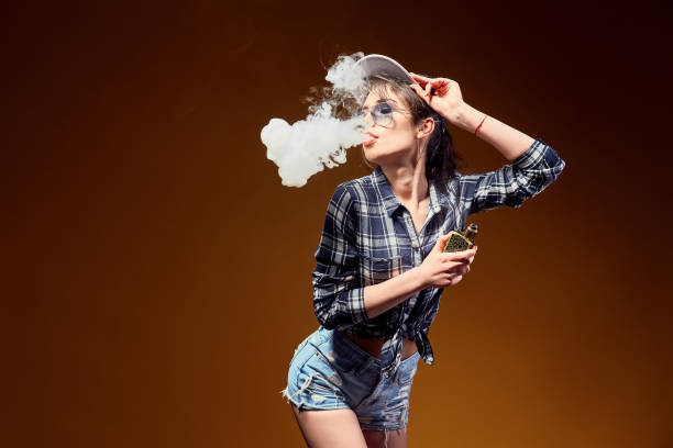 istock Woman standing and vaping in studio 1166673401