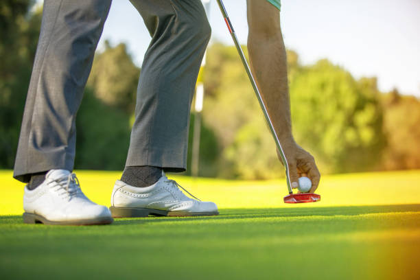 istock Close up  man putting golf ball on tee 1166674527