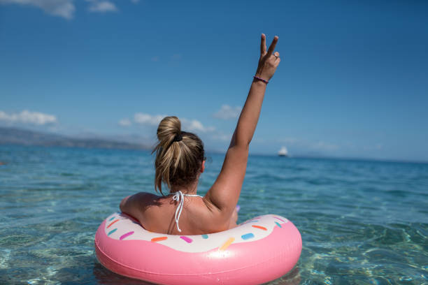 istock Beautiful young woman with pink donut circle 1166675723