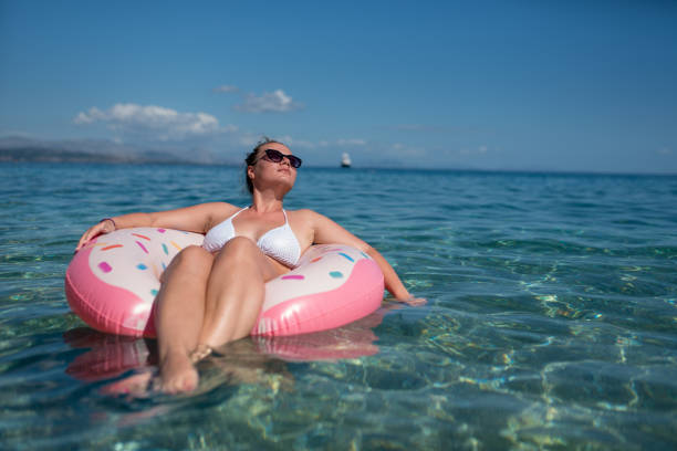 istock Beautiful young woman with pink donut circle 1166675837