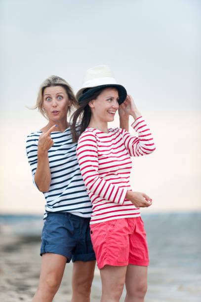 istock Two young women have fun together on the seaside 1166680525