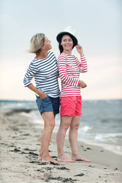 istock Two young women have fun together on the seaside 1166680768