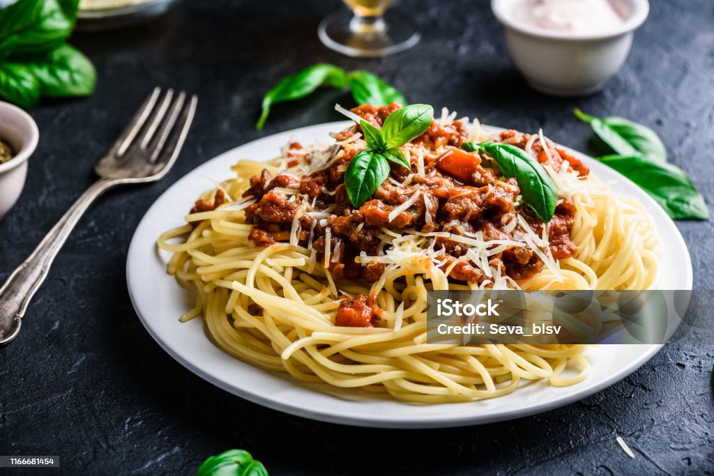 Spaghetti with bolognese sauce and parmesan cheese Spaghetti with bolognese sauce, grated parmesan cheese and fresh basil leaves Spaghetti Bolognese Stock Photo