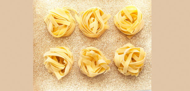 Fettuccine pasta on trendy background. The concept of Italian cuisine
