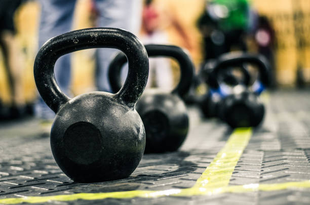 istock Different sizes of kettlebells weights lying on gym floor. 1166681874